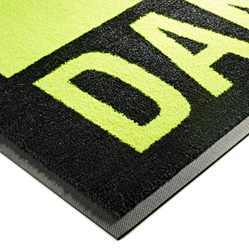 Rohož s výstražnou potlačou JET PRINT HI-VIS – detail žltých písmen na čiernom textilnom povrchu a okraja