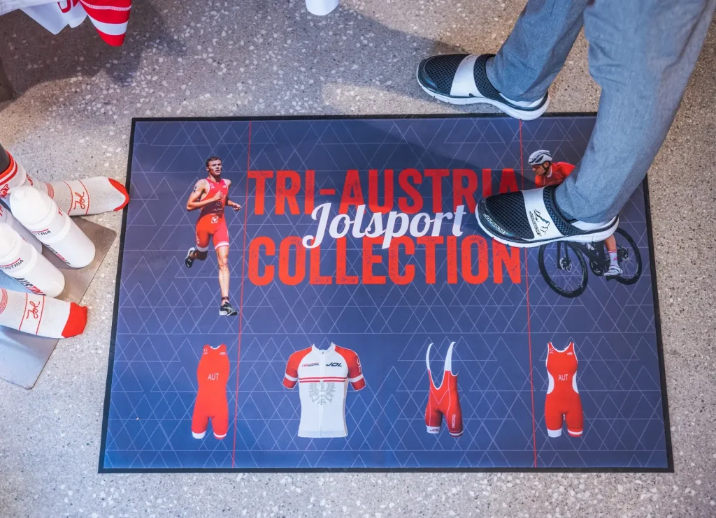 Rohož SUBLI MAT s potlačou TRI-AUSTRIA JOLSPORT COLLECTION a športovými motívmi v predajni