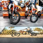 Rohož SUBLI MAT s fotografickou potlačou motocyklového jazdca a paliem pred vystavenými motocyklami